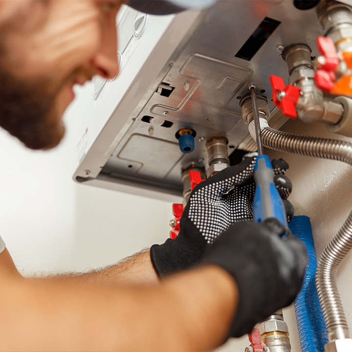 Image of a man servicing a boiler