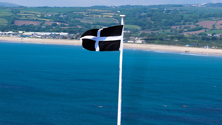 Picture of a Cornish flag against blue sea