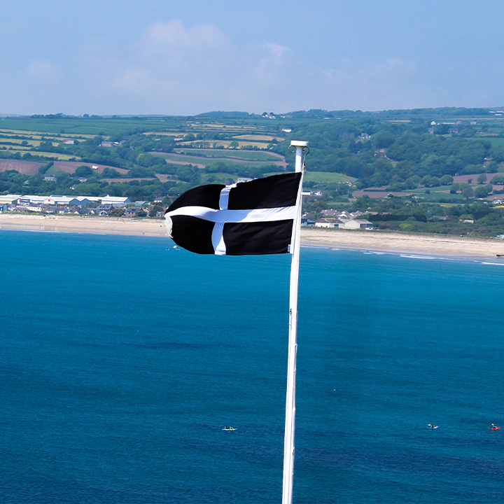 Picture of a Cornish flag against blue sea